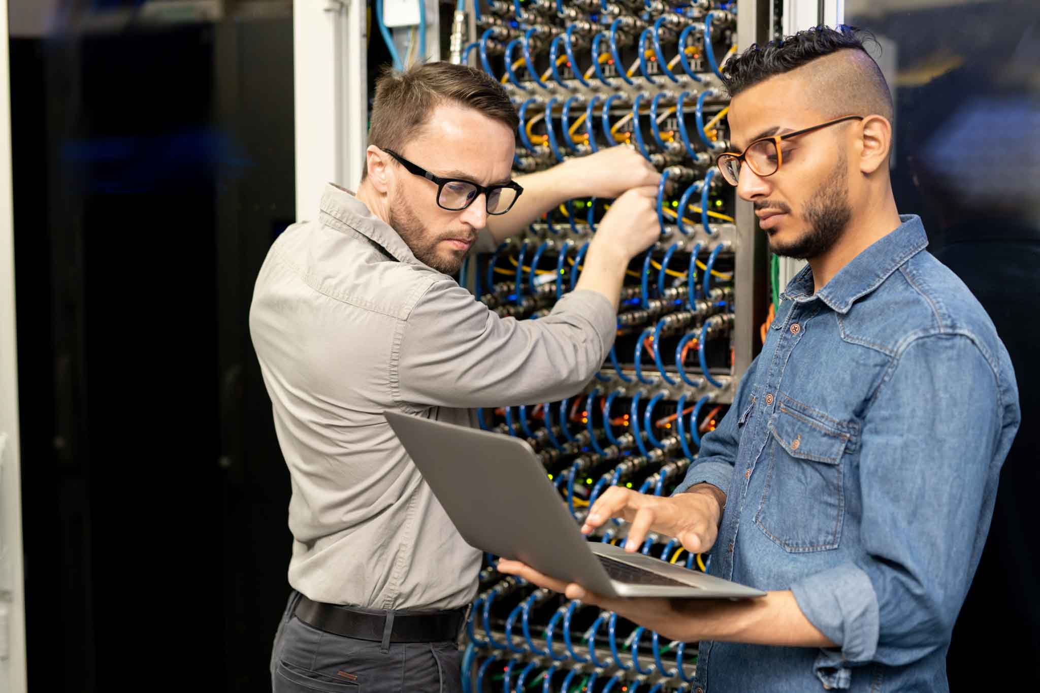 two IT professionals working in a datacenter